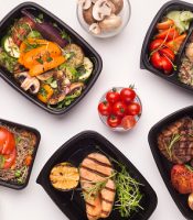 gettyimages-1165063882-170667a Restaurant healthy food delivery in take away boxes for daily nutrition on white background