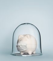 Safe economy under coronavirus concept image with piggy bank under glass jar wearing mask for protection against viruses